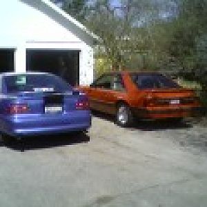 My Mustang to the left, My girlfriends dads foxbody to the right, and her brothers notchback tucked in the garage