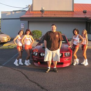 Kyle with car and Hooters girls
