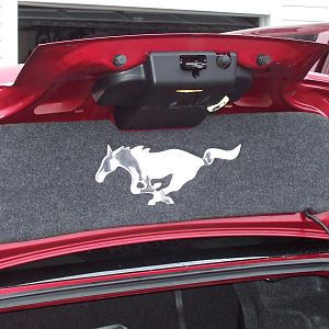 Trunk lid mat with polished stainless Pony
