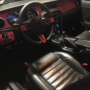 Interior with blood red carbon fiber vinyl.  Center console/radio surround painted satin black.  Steering wheel spokes also same scheme.
